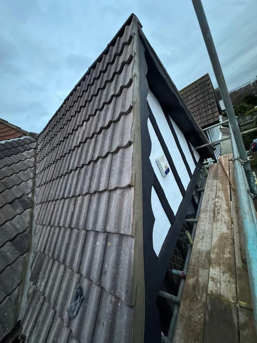 Tile-hung dormer cheek above scaffold boards