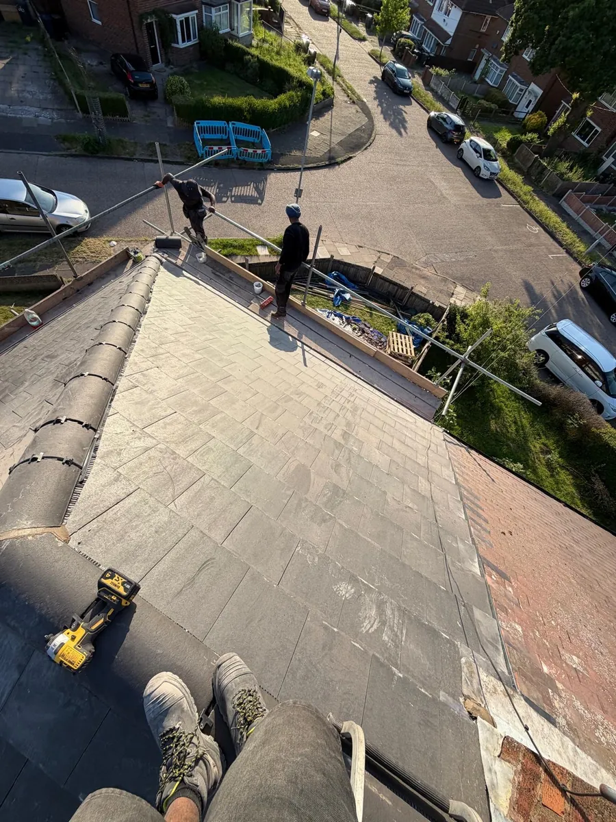 Hip roof ridge with tools and scaffolding below