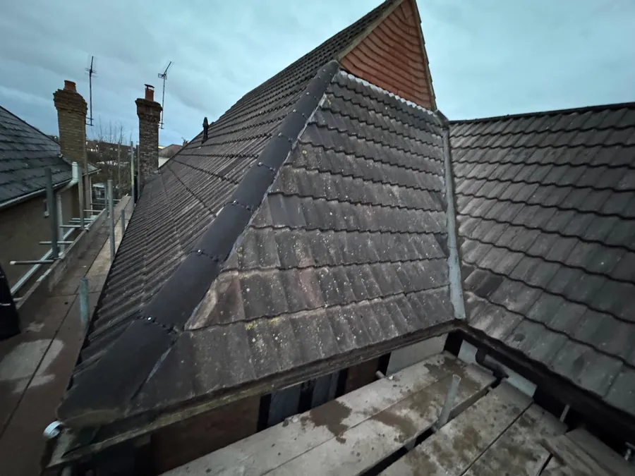 Lead hip detail above scaffold boards and a gutter