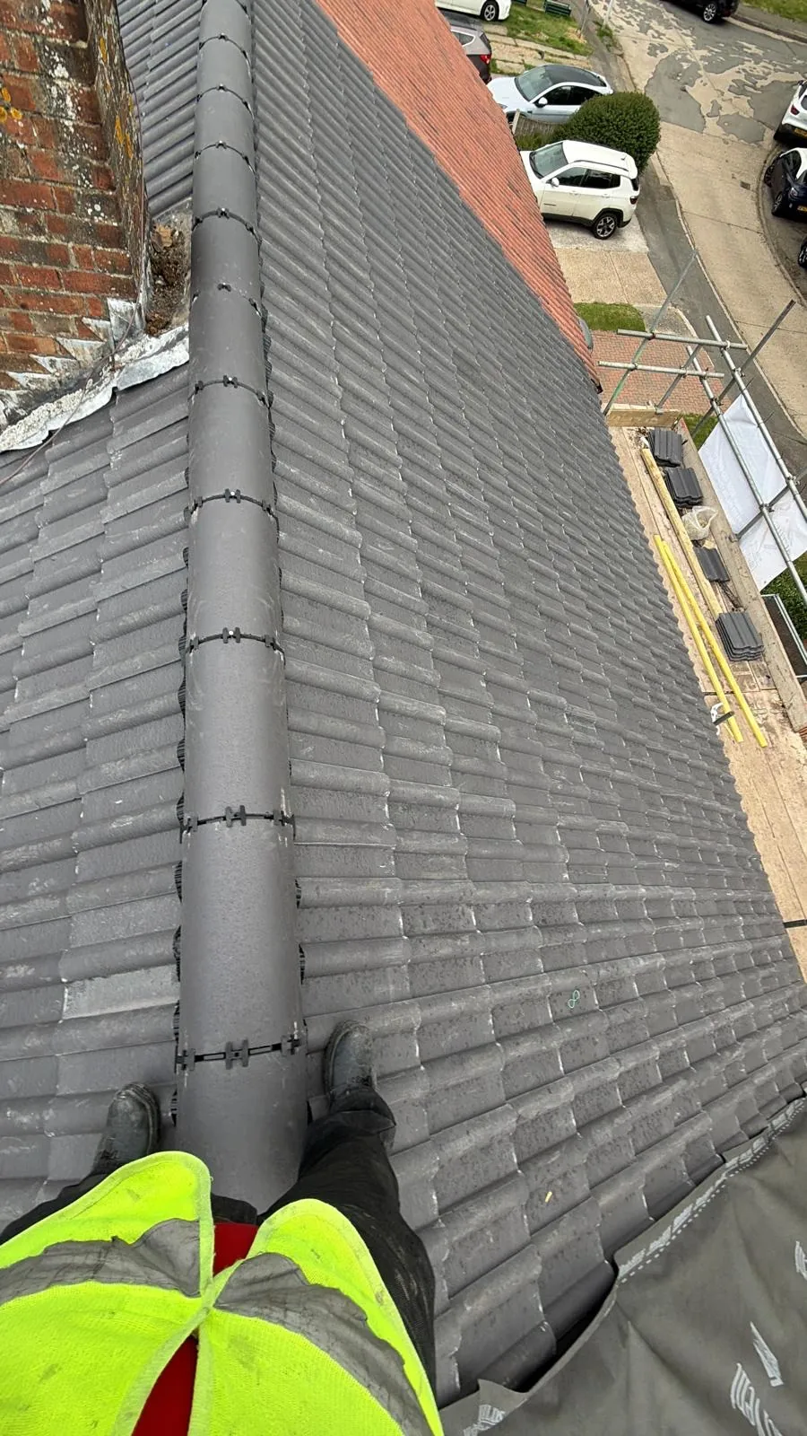 Grey ridge and tile courses beside a brick chimney