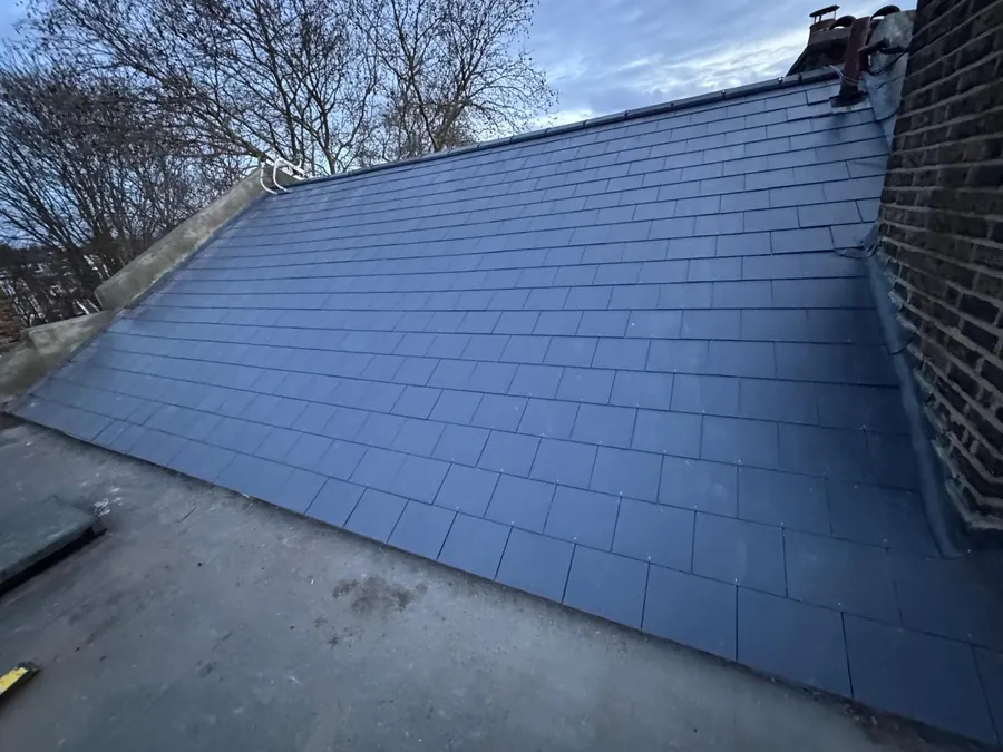 Slate-effect tile slope where it meets a flat roof