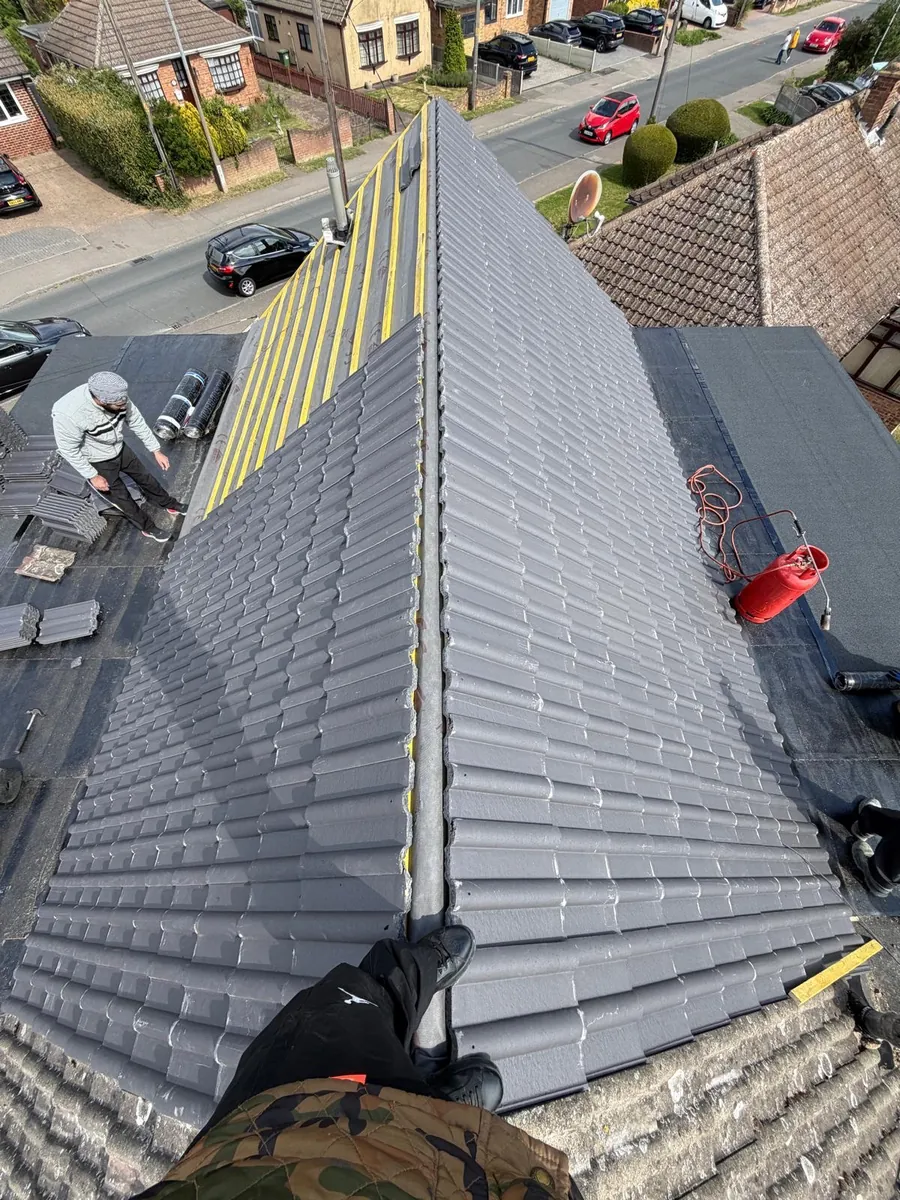 New grey tiles beside exposed battens at the roof edge