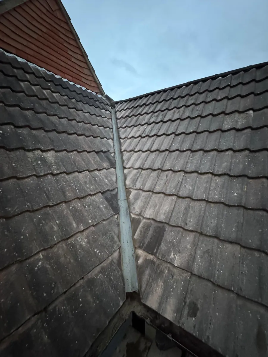 Lead valley running down between interlocking tile slopes